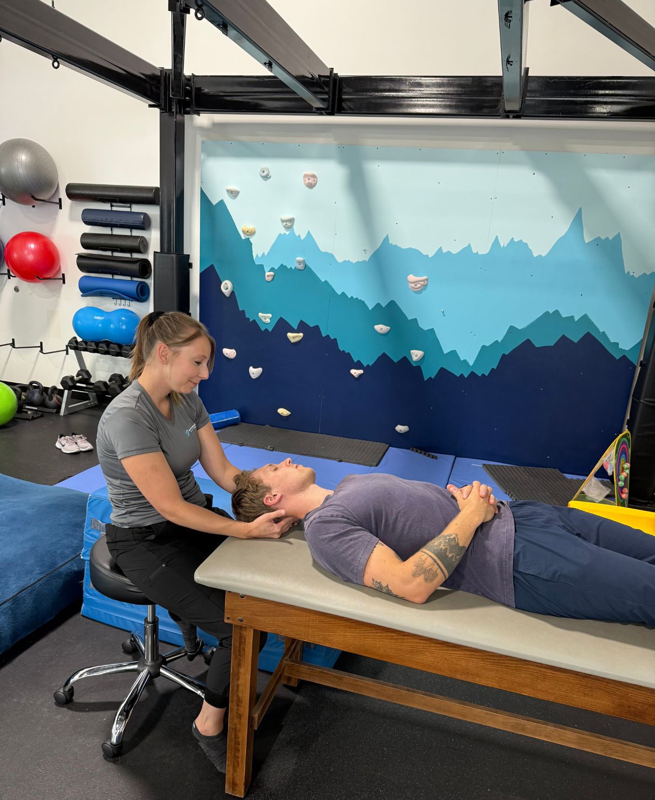 Physical therapist working with an adult client on a treatment table